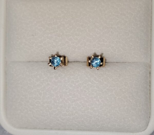 Aretes en oro de 18k con topacios azules – 1 gramo 3 USD.