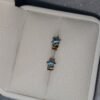 Aretes en oro de 18k con topacios azules – 1 gramo 3 USD.